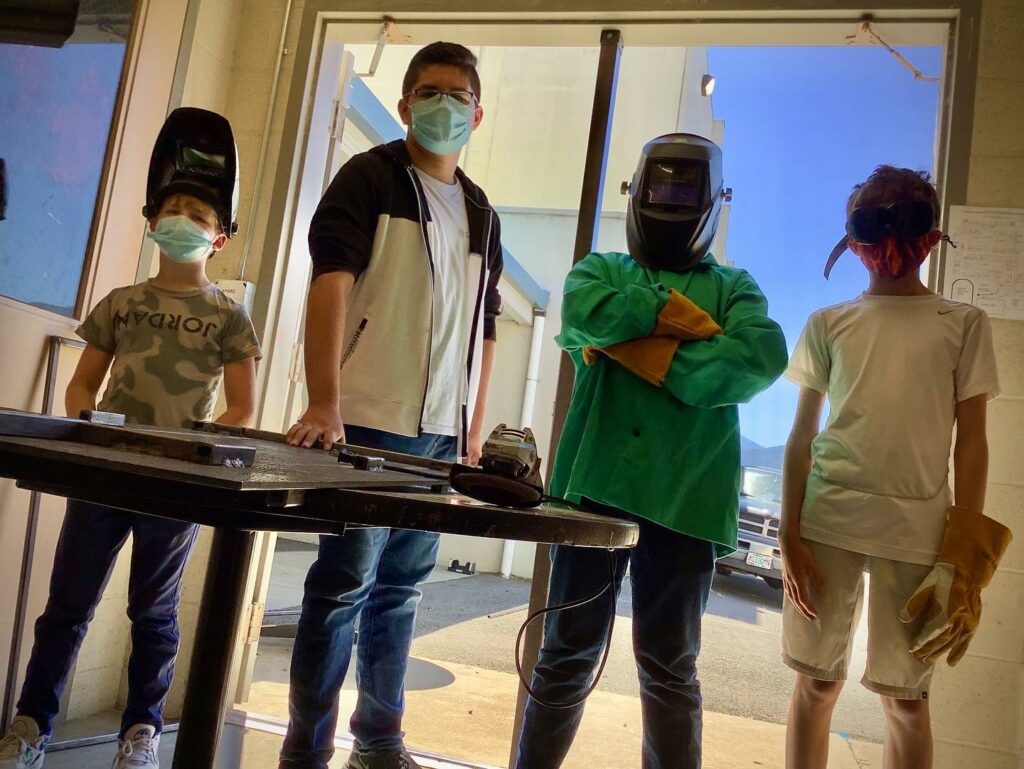 Kids in welding masks at Talent Maker City